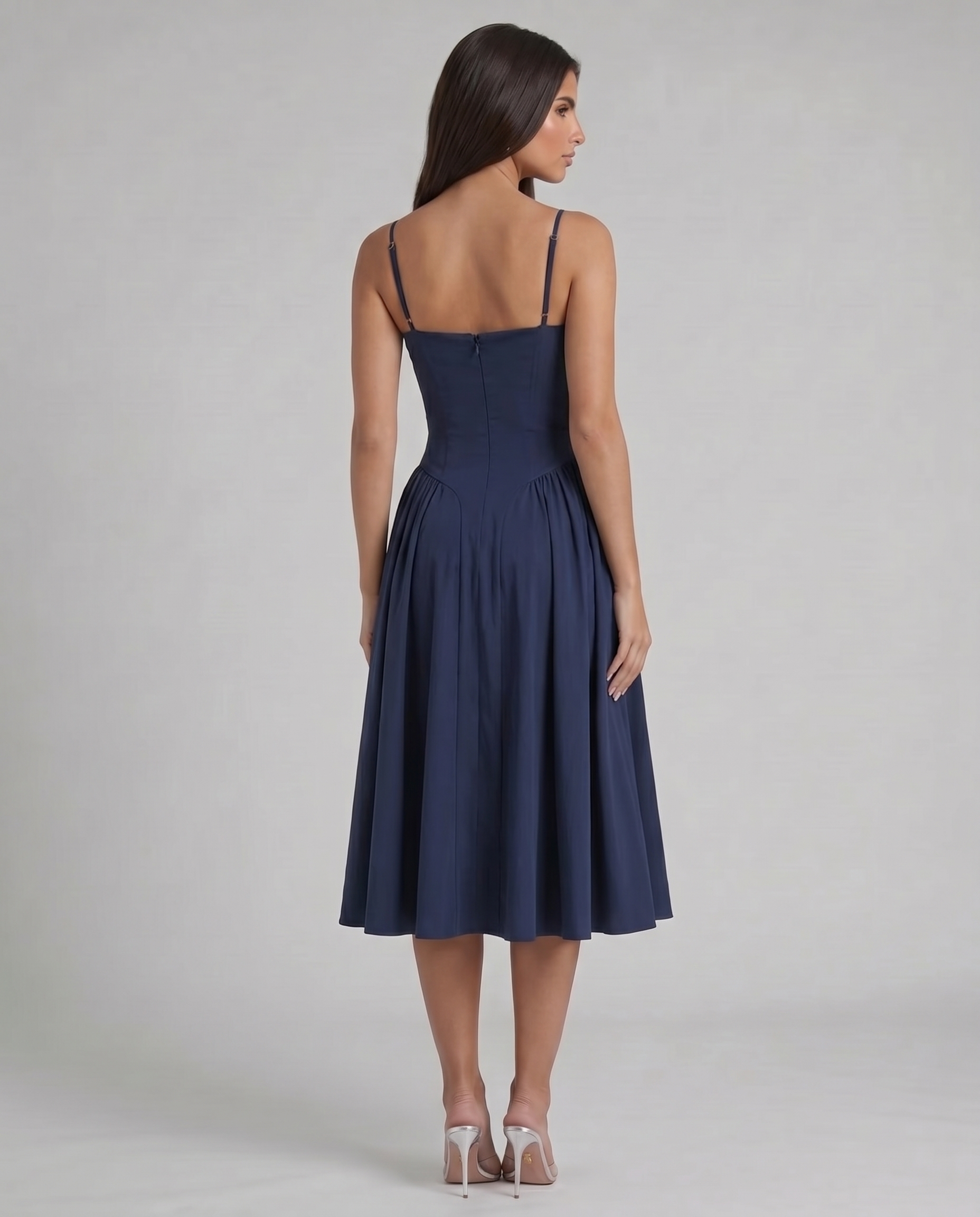 Back view of blue midi dress showing slim straps, fitted bodice seams and center back zipper closure
