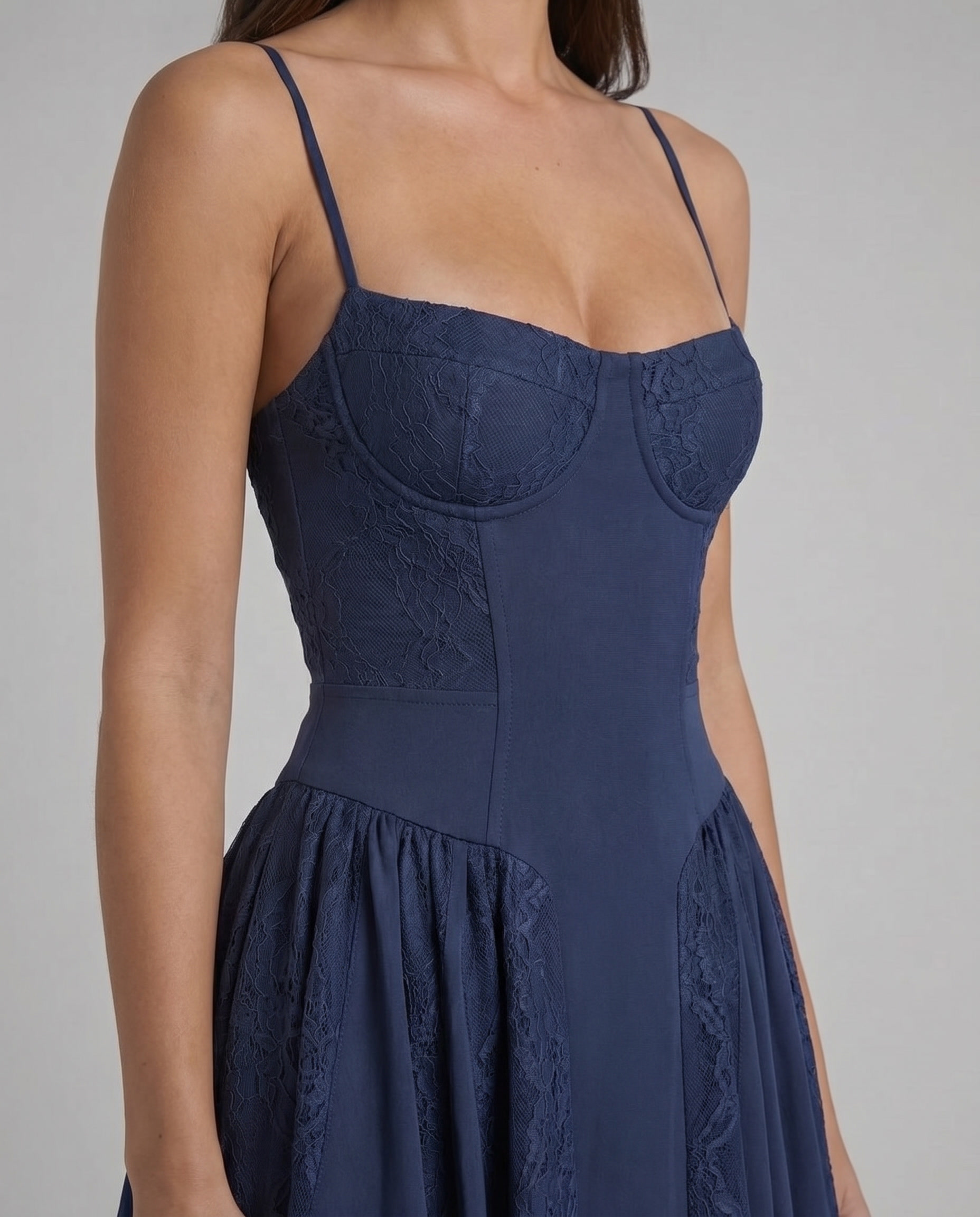 Detail of blue midi dress showing lace overlay on the bust and smooth fitted bodice with thin straps
