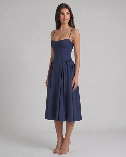 Three-quarter front view of blue midi dress with structured bust cups, fitted waist and draped skirt