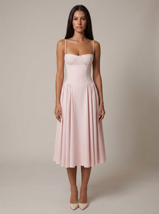 Front view of blush pink midi dress with sweetheart bustier bodice, spaghetti straps, and flared skirt