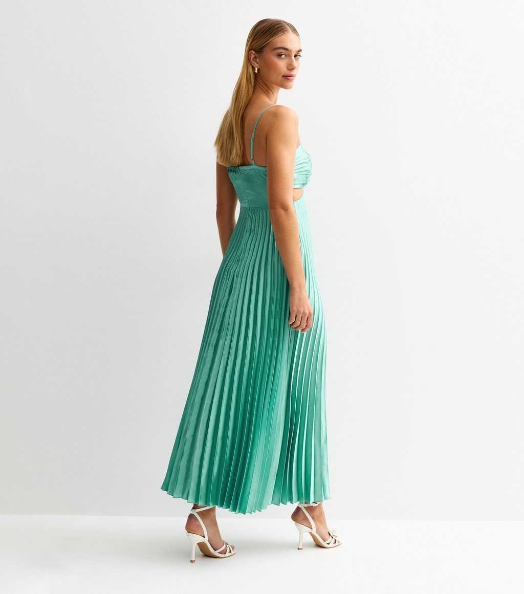 Back three-quarter view of aqua blue satin plisse midi dress showing pleated skirt and straps