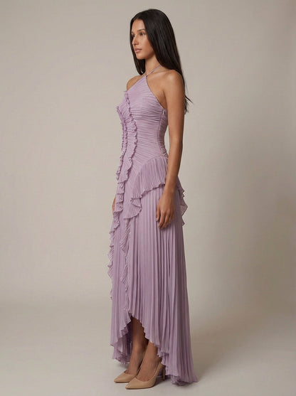 Angled front view of lavender pleated maxi dress with ruffle trim and flowing chiffon high-low skirt