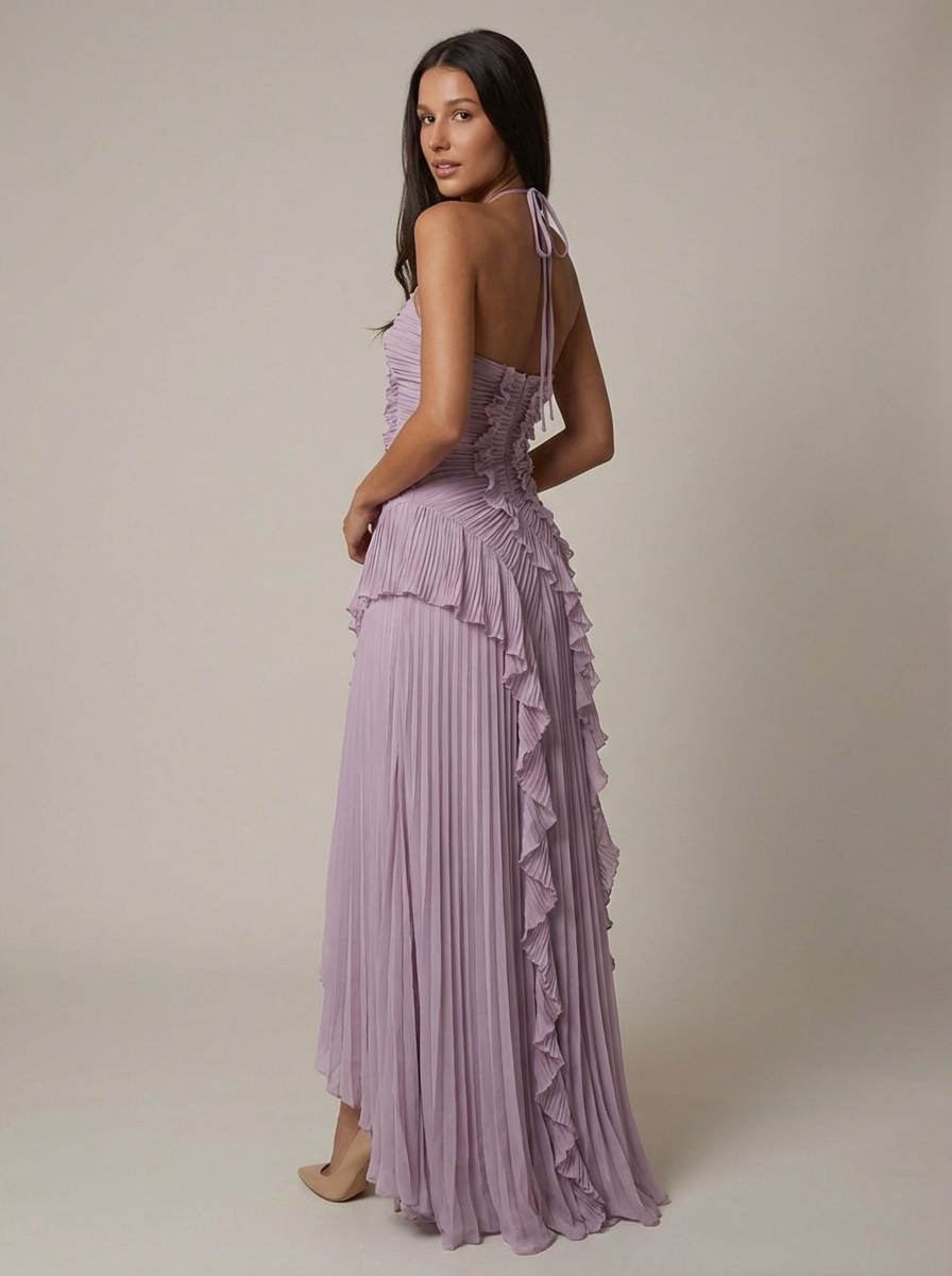 Back angled view of lavender maxi dress with open back tie halter and pleated ruffle skirt