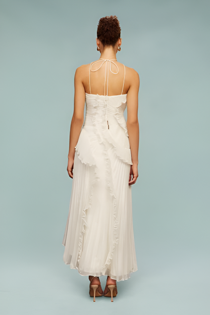 Back view of white maxi dress with tie-back halter straps, fitted bodice and pleated skirt