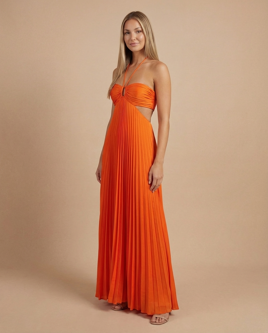 Three-quarter side view of orange pleated maxi dress highlighting waist cutout and floor-length hem