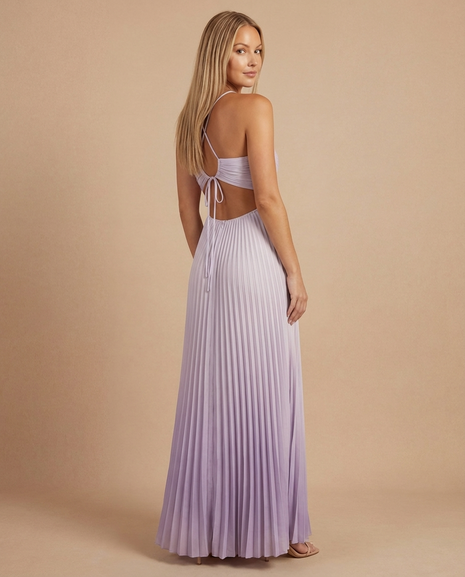 Angled back shot of soft pink maxi dress with pleated skirt, open back and adjustable tie detail