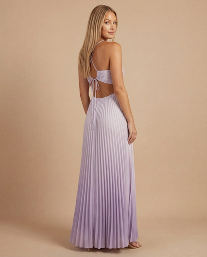 Angled back shot of soft pink maxi dress with pleated skirt, open back and adjustable tie detail