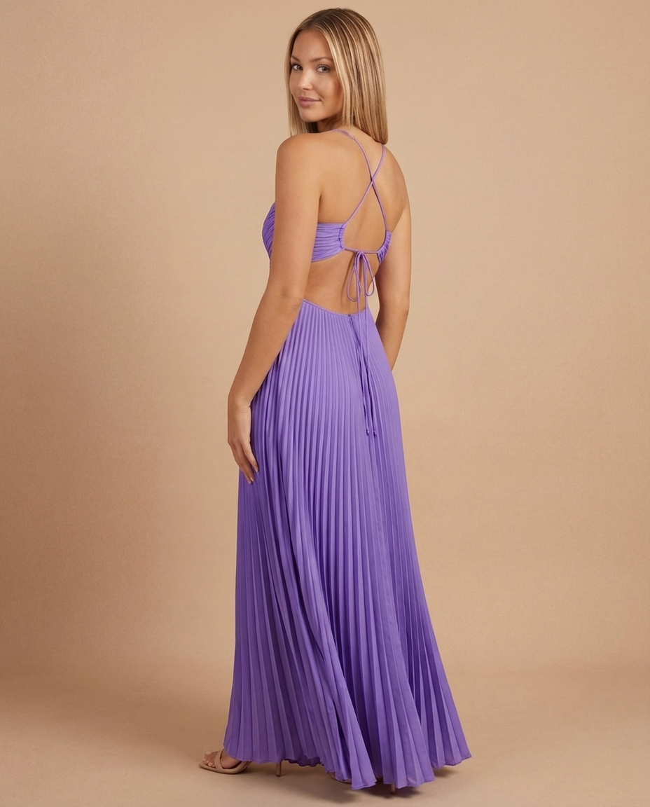 Back view of purple pleated maxi dress with open back, crisscross straps and tie closure