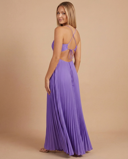 Back view of purple pleated maxi dress with open back, crisscross straps and tie closure