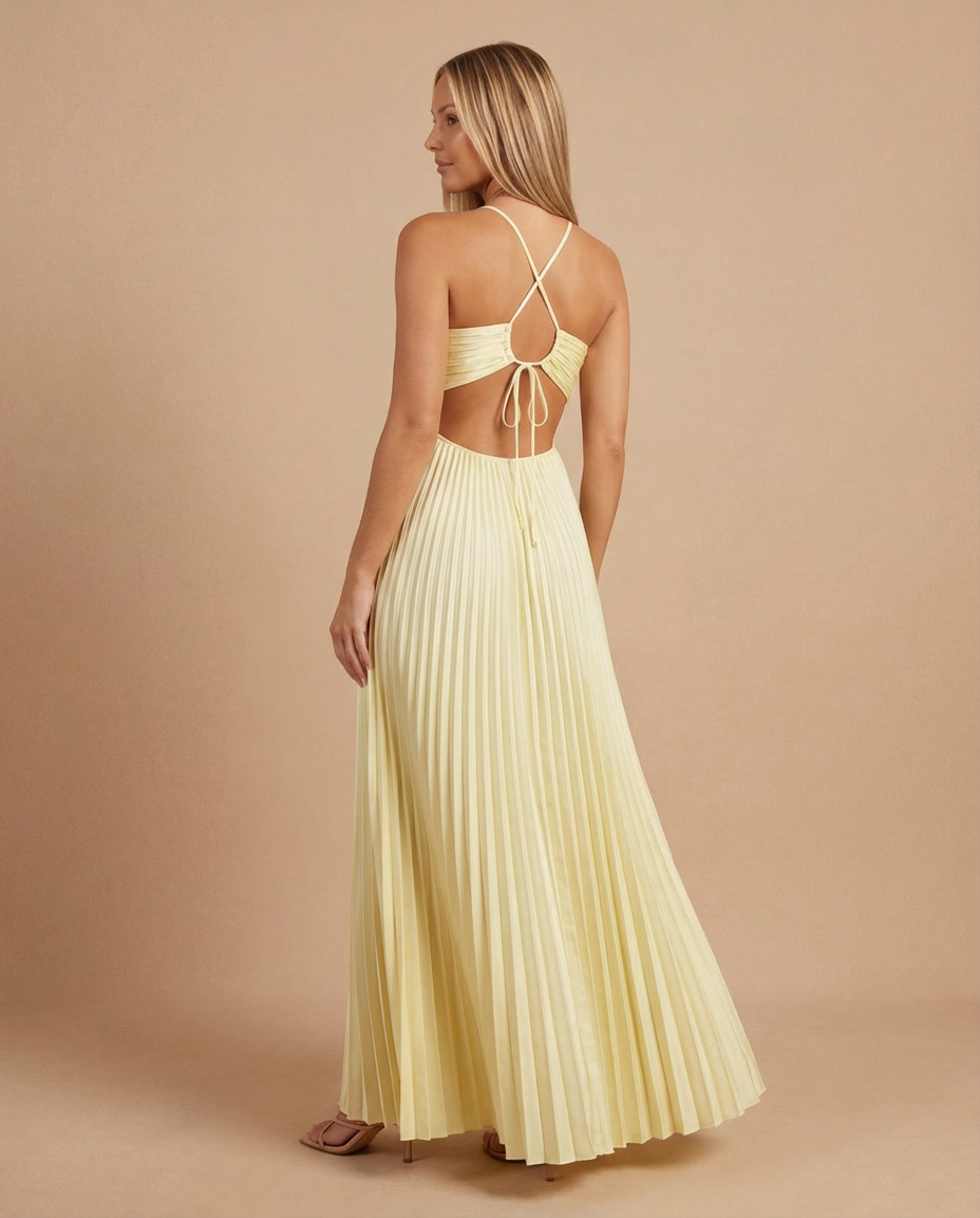 Back view of yellow pleated maxi dress with crisscross straps, open back and adjustable tie detail