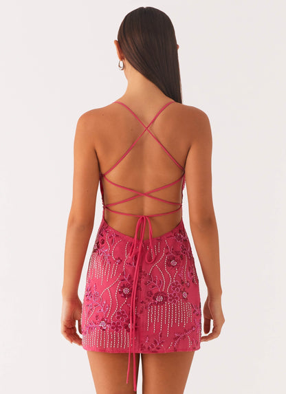 Back view fuchsia sequin mini dress with crisscross lace-up straps and low open back