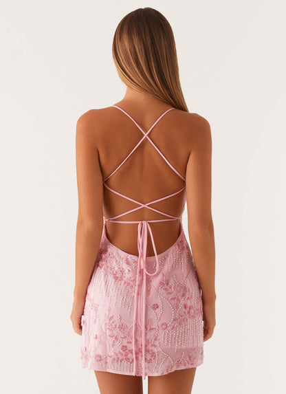 Pink sequin mini dress with open crisscross back straps and tie detail, back view for women