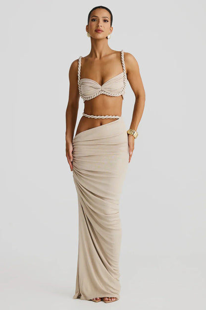 Full-length front view of cream two-piece outfit with rope trim bralette and draped maxi skirt